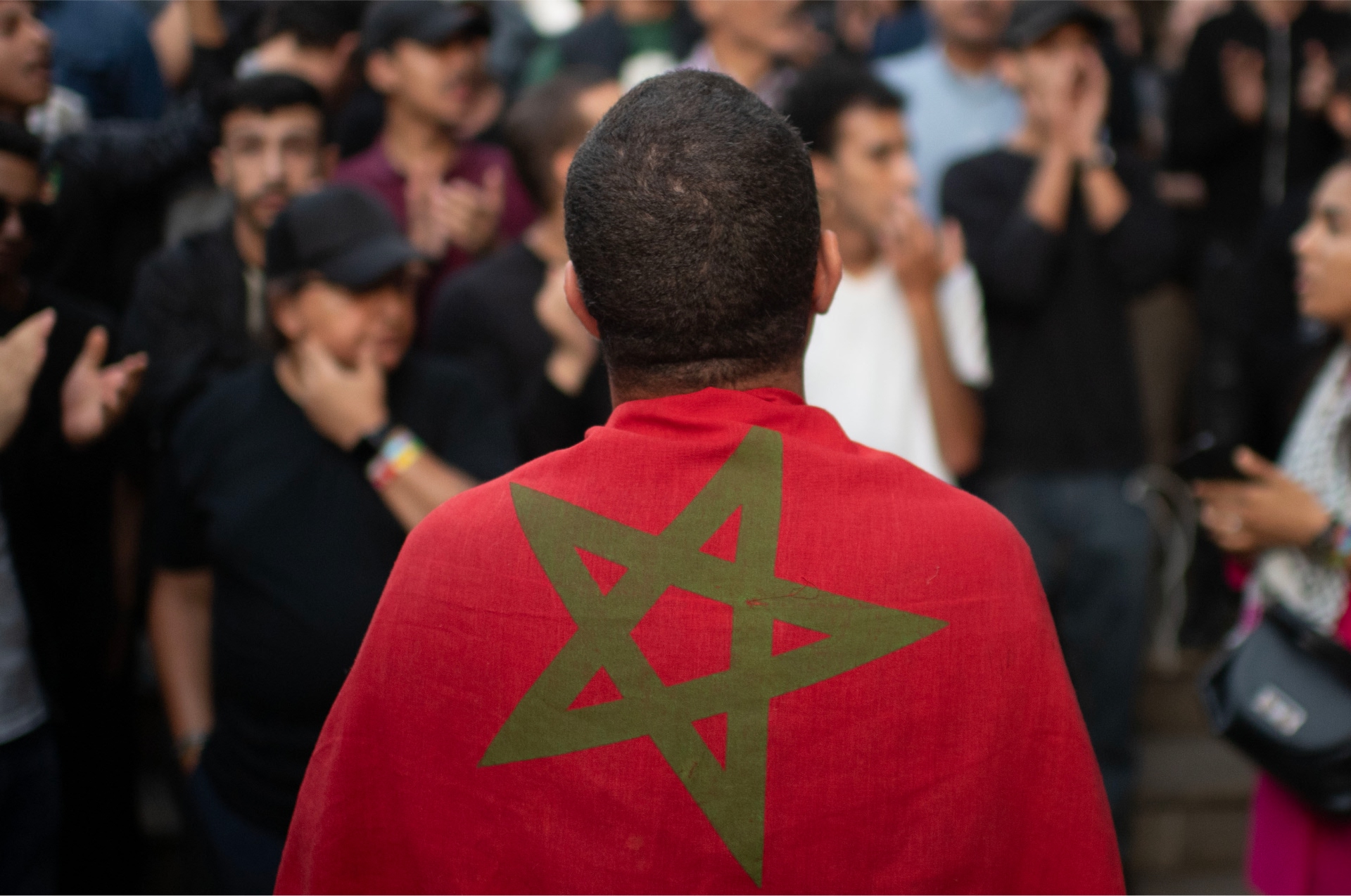 Joven con una bandera de Marruecos sobre los hombros