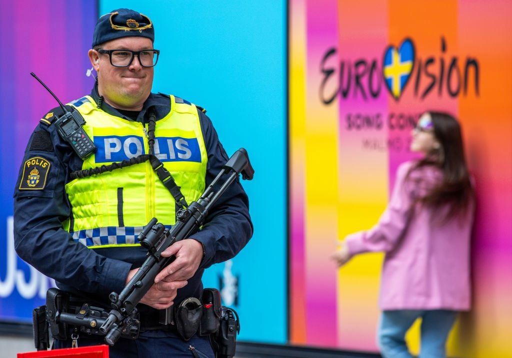 11 May 2024, Sweden, Malmö: An armed police officer secures the Malmö Arena ahead of the final of the Eurovision Song Contest (ESC) 2024. 25 countries will now compete in the final of the world's biggest singing competition under the motto "United By Music" after the Netherlands' candidate was officially excluded from the competition. Photo: Jens Büttner/dpa (Photo by Jens Büttner/picture alliance via Getty Images)