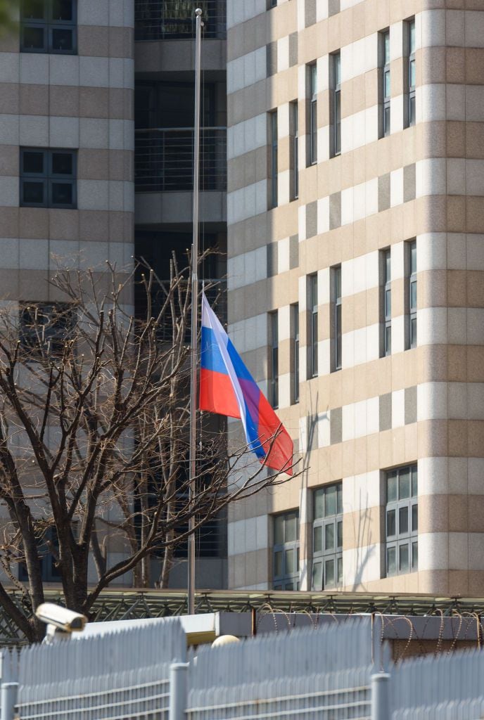 SEOUL, SOUTH KOREA - 2024/03/23: A Russia flag hangs at the Russian embassy, commemorating those killed in the Moscow terrorist attack. Unidentified assailants burst into a concert at the Krokus City Hall in Krasnogorsk, near Moscow on March 22 and sprayed the crowd with gunfire, killing over 60 people, injuring more than 100 and setting fire to the venue. Islamic State claimed responsibility for the attack. (Photo by Kim Jae-Hwan/SOPA Images/LightRocket via Getty Images)