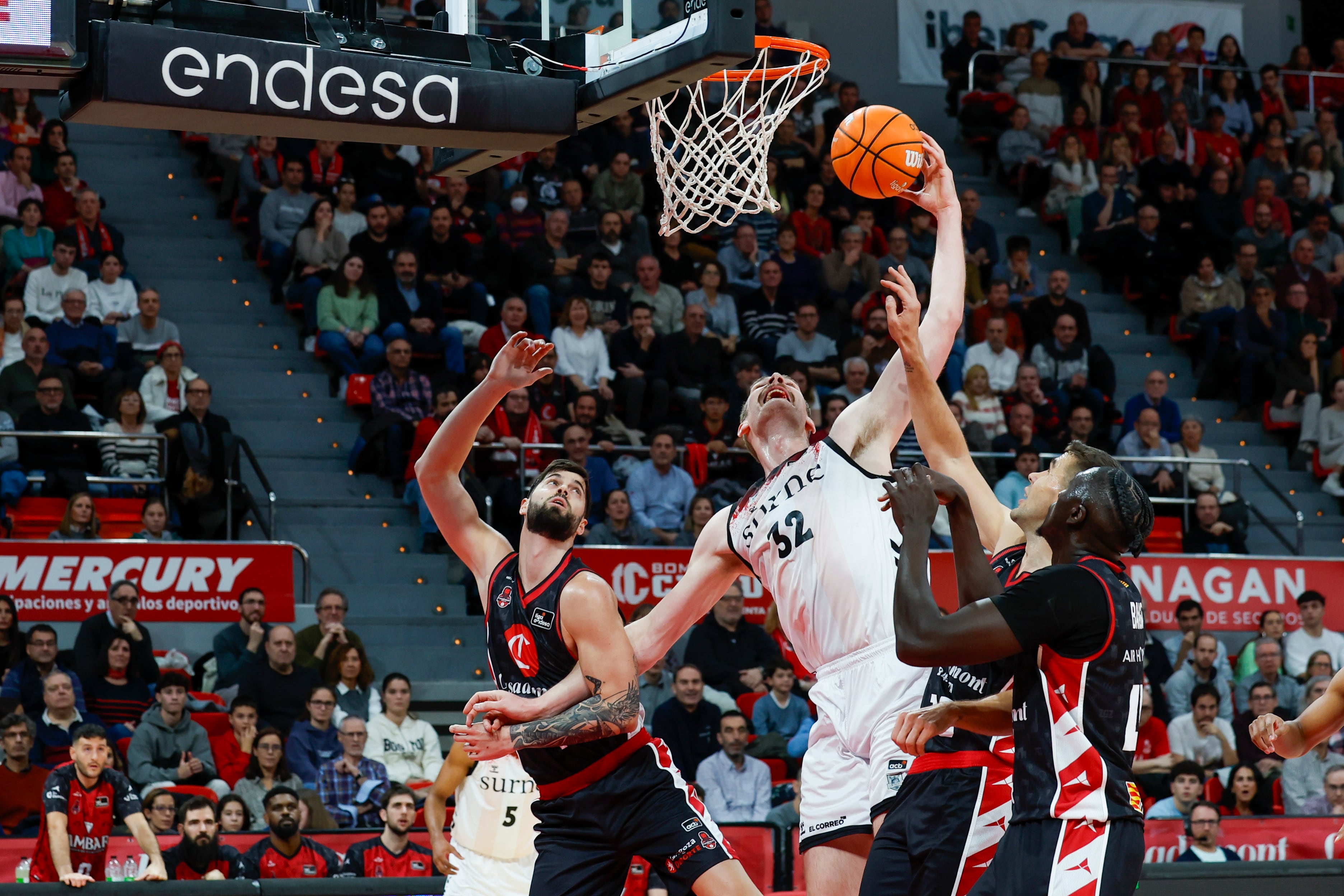 ZARAGOZA, 30/11/2024.- El pívot del Bilbao Basket Tryggvi Hlinason (c) trata de anotar entre dos jugadores del Casademont, durante el partidomde la ¨Liga Endesa de baloncesto disputado este sábado en Zaragoza. EFE/Javier Cebollada
