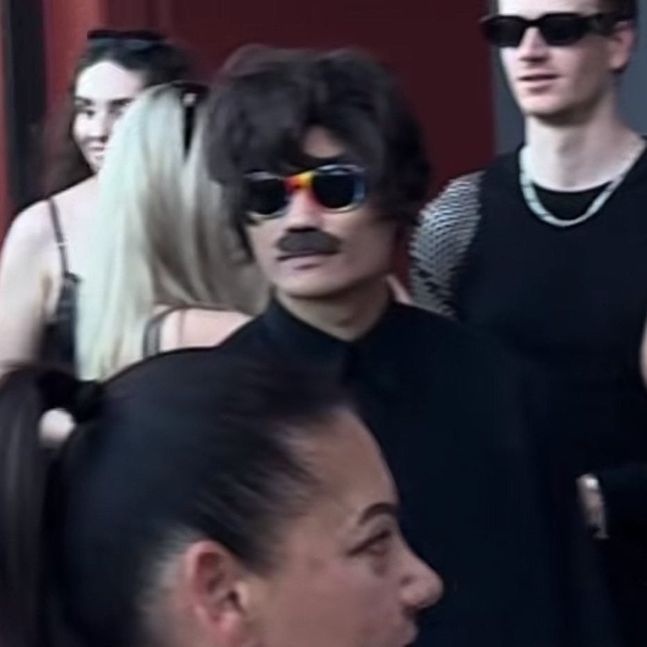 Johnson Wen con peluca y bigote postizo antes de ser expulsado de un concierto de Lady Gaga