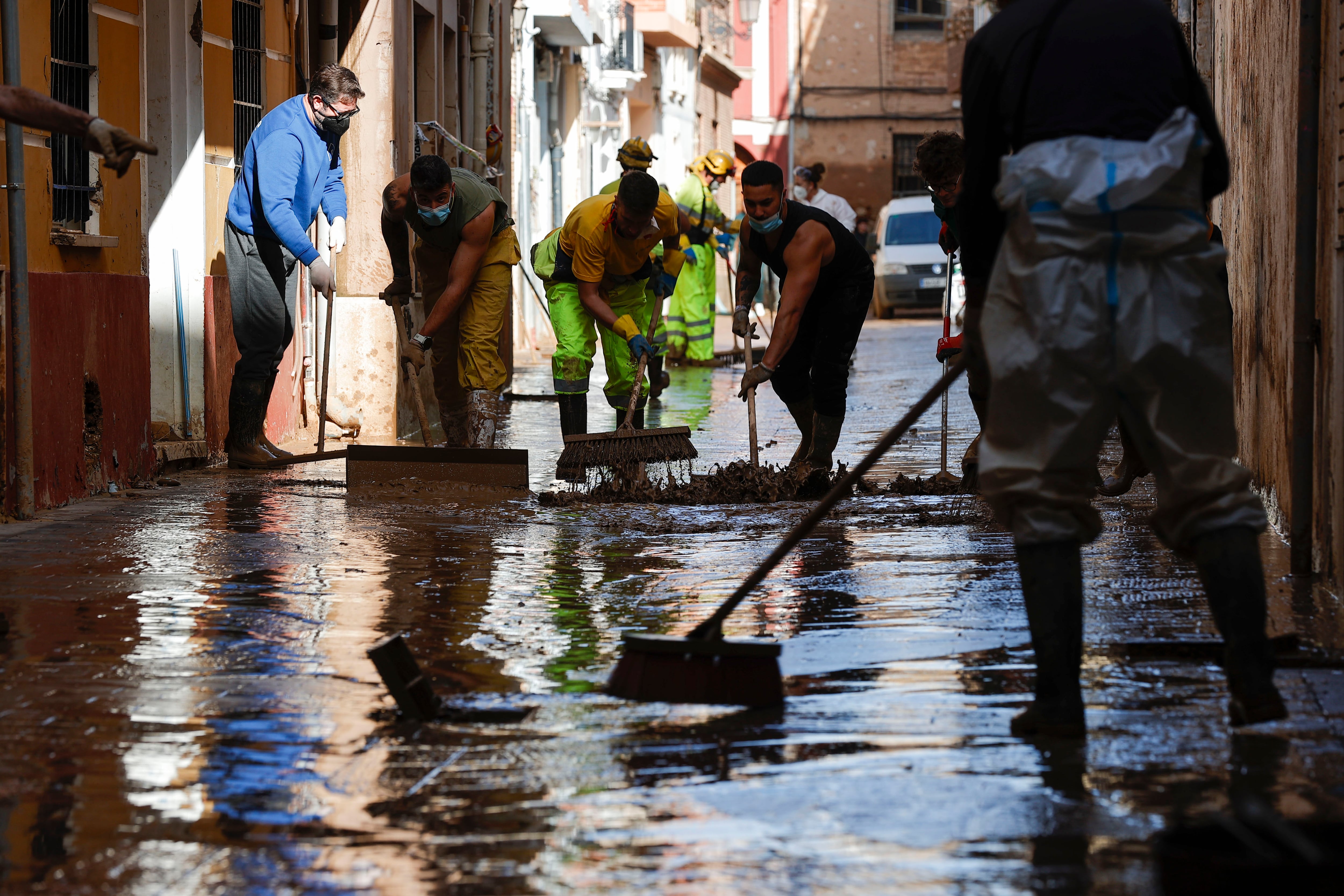 Efectivos y voluntarios ayudan a limpiar las calles de Paiporta.