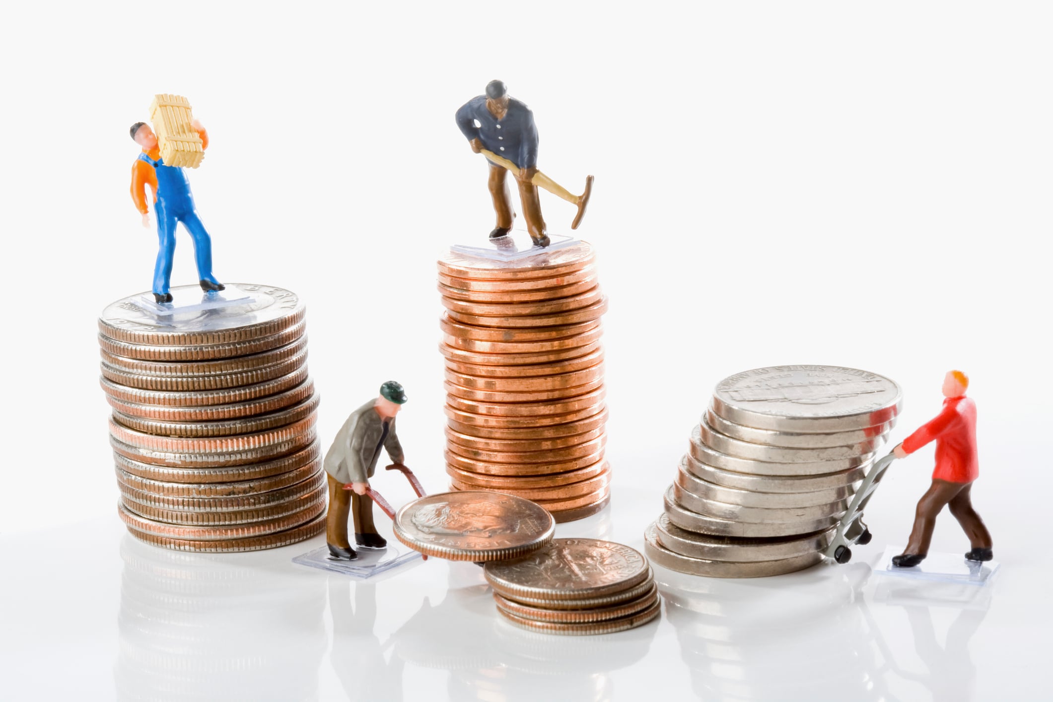 Figurines of manual workers with stacks of coins