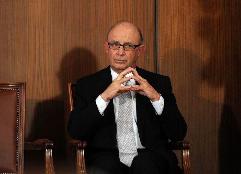 Spanish Minister of the Treasury and Public Administrations Cristobal Montoro sits during the investiture ceremony for the new President of regional government of Andalusia in the &quot;Usos Multiples del Parlamento&quot; room at the Parliament in Sevilla on June 1