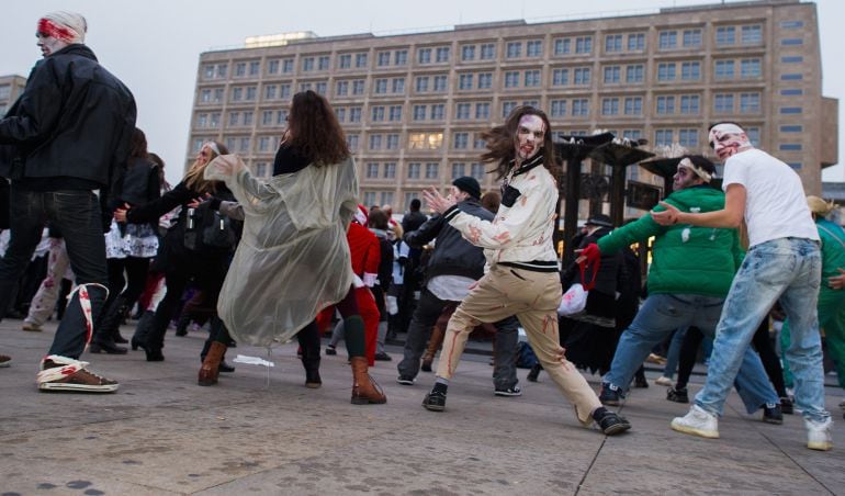 BERLIN, GERMANY - OCTOBER 25:  Zombie enthusiasts walk over the Alexanderplatz as part of a flashmob on October 25, 2014 in Berlin, Germany. Over 150 participants dressed as zombies gathered for a so called &#039;zombie walk&#039;  (Photo by Target Presse Agentur G