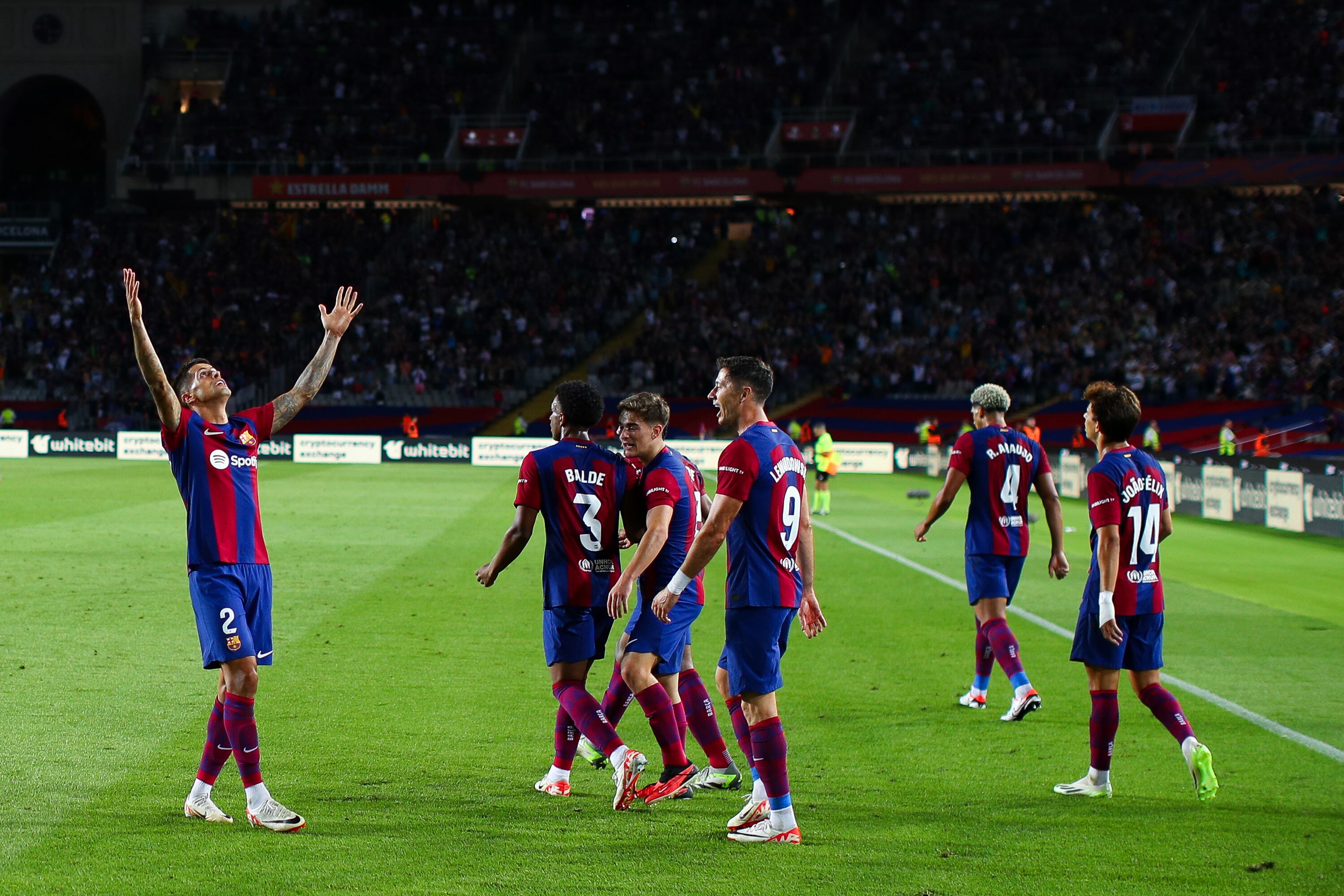 BARCELONA, SPAIN - SEPTEMBER 23: Joao Cancelo of FC Barcelona celebrates with his teammates after scoring the team's third goalduring the LaLiga EA Sports match between FC Barcelona and Celta Vigo at Estadi Olimpic Lluis Companys on September 23, 2023 in Barcelona, Spain. (Photo by Eric Alonso/Getty Images)