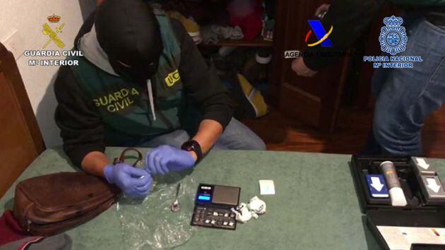 Agentes de la Policía Nacional y de la Guardia Civil analizando la droga incautada en uno de los registros.