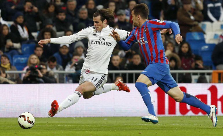 GRA359. MADRID, 15/03/2015.- El jugador del Real Madrid Gareth Bale (i) se dispone a pasar un balón ante Toño, del Levante, durante el partido de Liga en Primera División disputado esta noche en el estadio Santiago Bernabéu, en Madrid. EFE/Juan Carlos Hidalgo