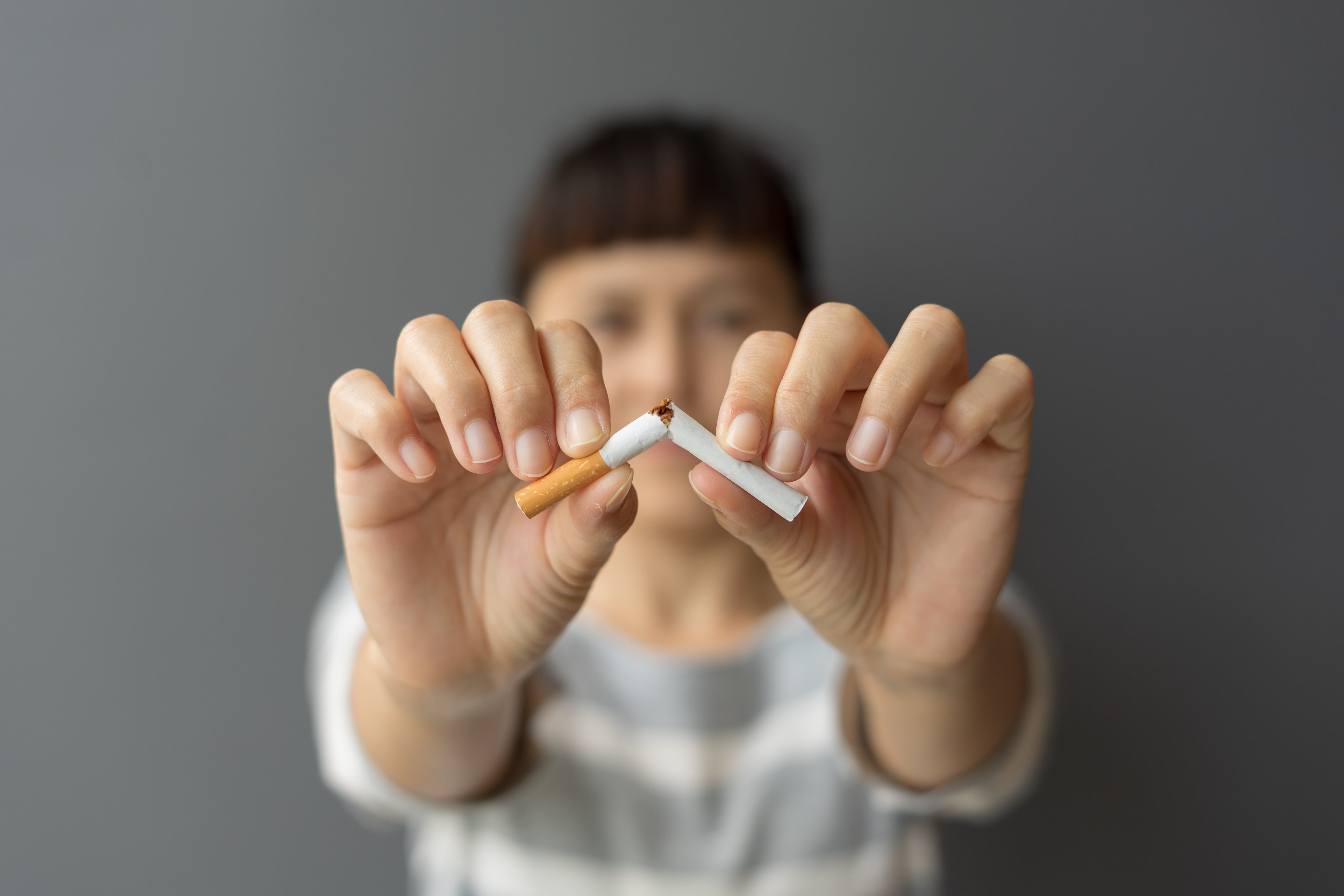 Una mujer rompe un cigarro / GETTY