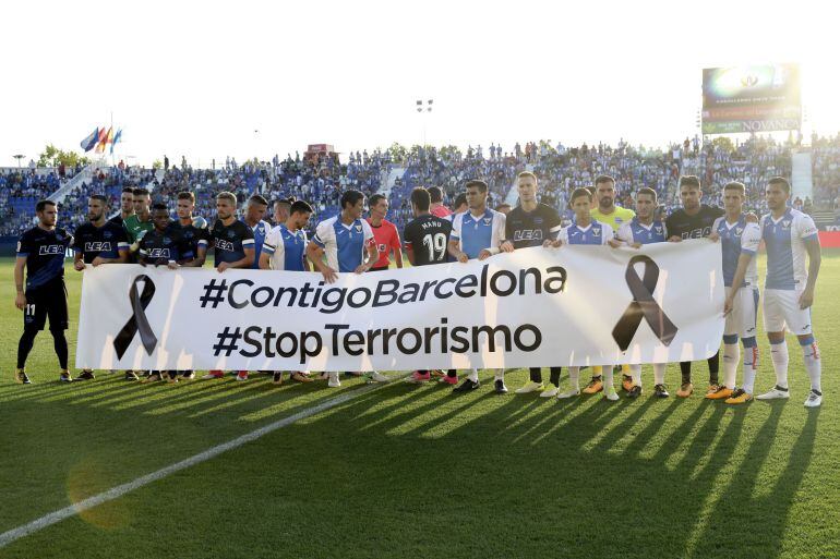 Los jugadores del Leganés y el Alavés muestran una pancarta de apoyo a las víctimas y condena de los atentados de ayer en Cataluña.