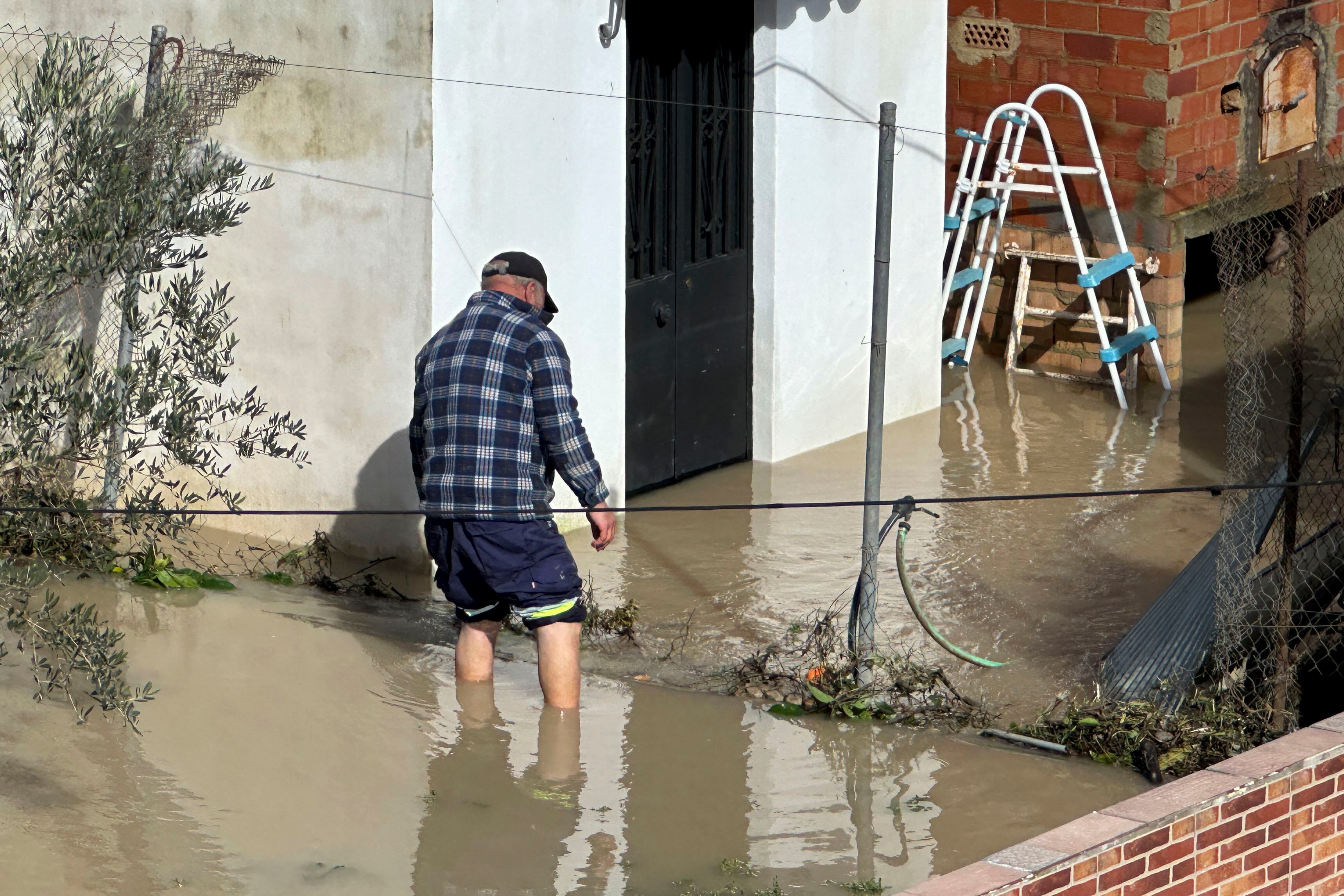 ARCOS DE LA FRONTERA (CÁDIZ), 06/02/2026.- Un hombre en una zona inundada de Arcos de la Frontera, este viernes. Todos los pasos para cruzar el río están cerrados y se teme por uno de los puentes, Puente de San Miguel, que ya presenta una gran fractura en su estructura y la fuerza con la que baja el agua puede terminar de derribarlo. EFE/ David Arjona