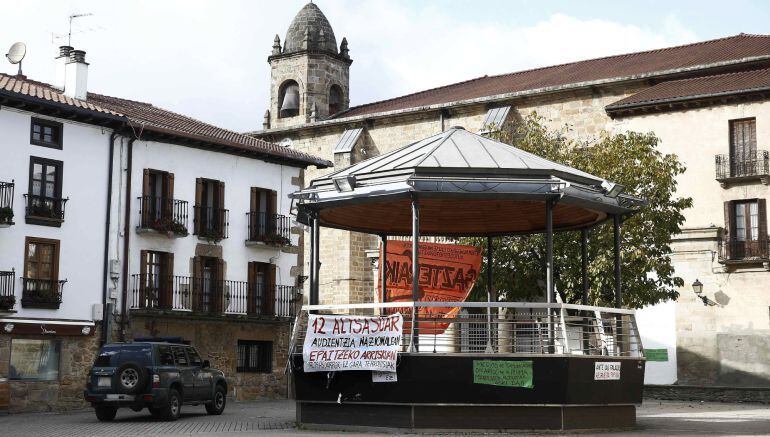 Un vehículo de la Guardia Civil pasa junto al kiosko de la Plaza de Alsasua donde se colocaron varias pancartas tras las detenciones por la agresión