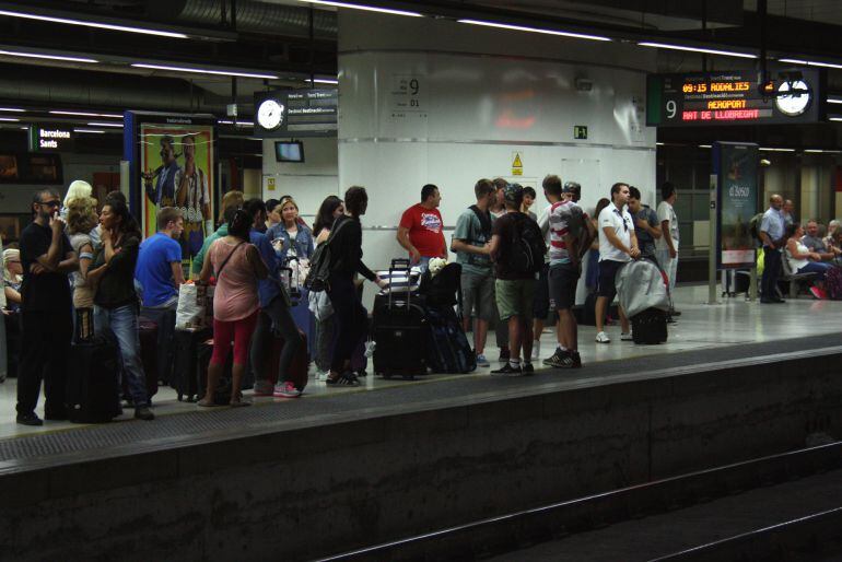 Usuaris esperant el tren a l'andana de l'estació de Sants