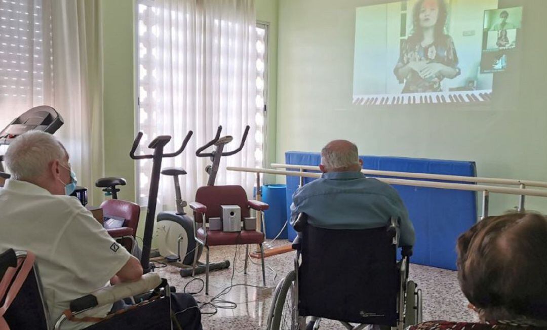 Ancianos viendo una pantalla en una residencia