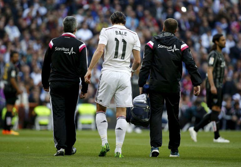 Bale abandona el césped del Bernabéu junto a los médicos del club blanco después de lesionarse ante el Málaga