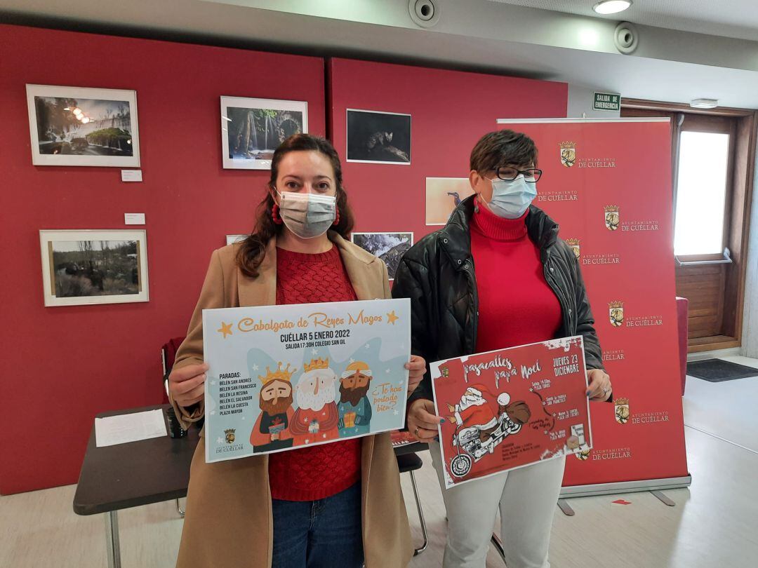 Maite Sanchez y Raquel Gilsanz muestran los carteles de la Cabalgata de Reyes y el pasacalles de Papá Noel.