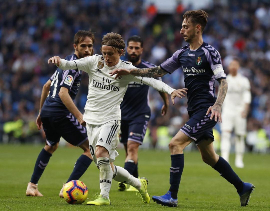 Luka Modric y Fernando Calero se disputan el balón