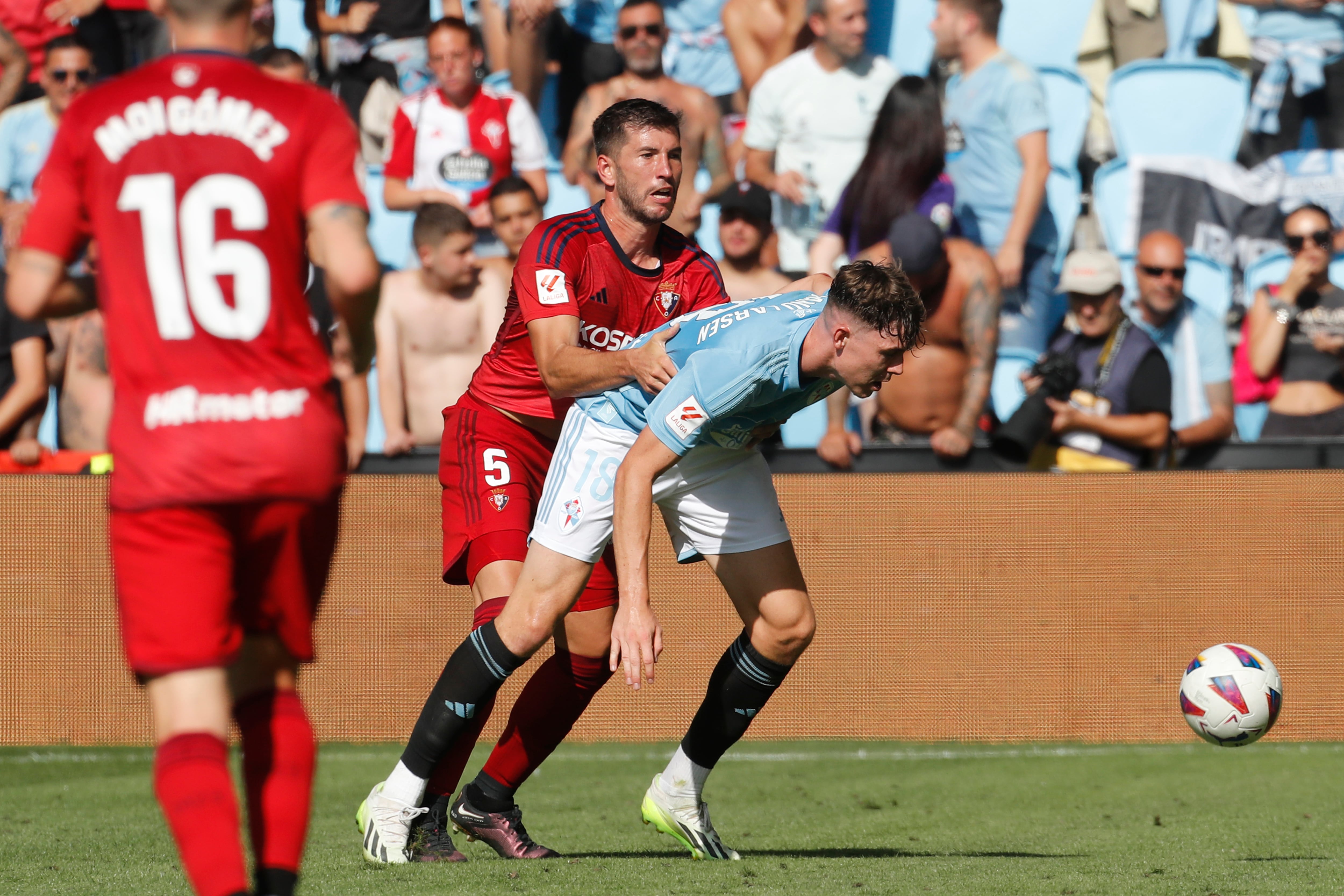 VIGO (PONTEVEDRA), 13/08/2023.- El jugador del Celta de Vigo Jorgen Larsen (d), disputa un balón con David García (c), del Osasuna, durante el partido de la jornada 1 de LaLiga que disputan el Celta de Vigo y el Osasuna este domingo en el estadio de Balaídos en Vigo.- EFE/ Salvador Sas
