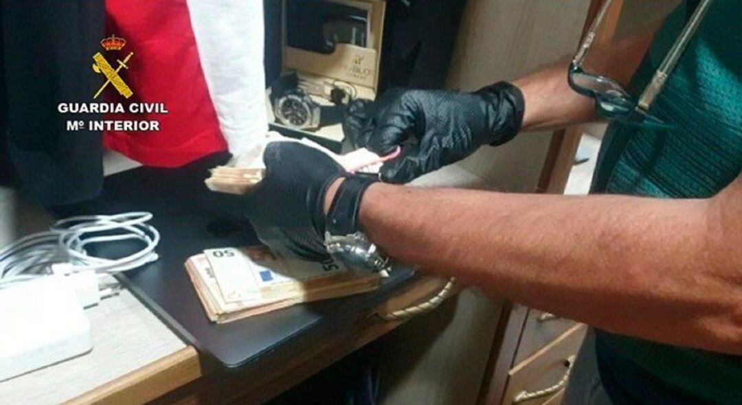 Un agente cuenta dinero en uno de los registros.