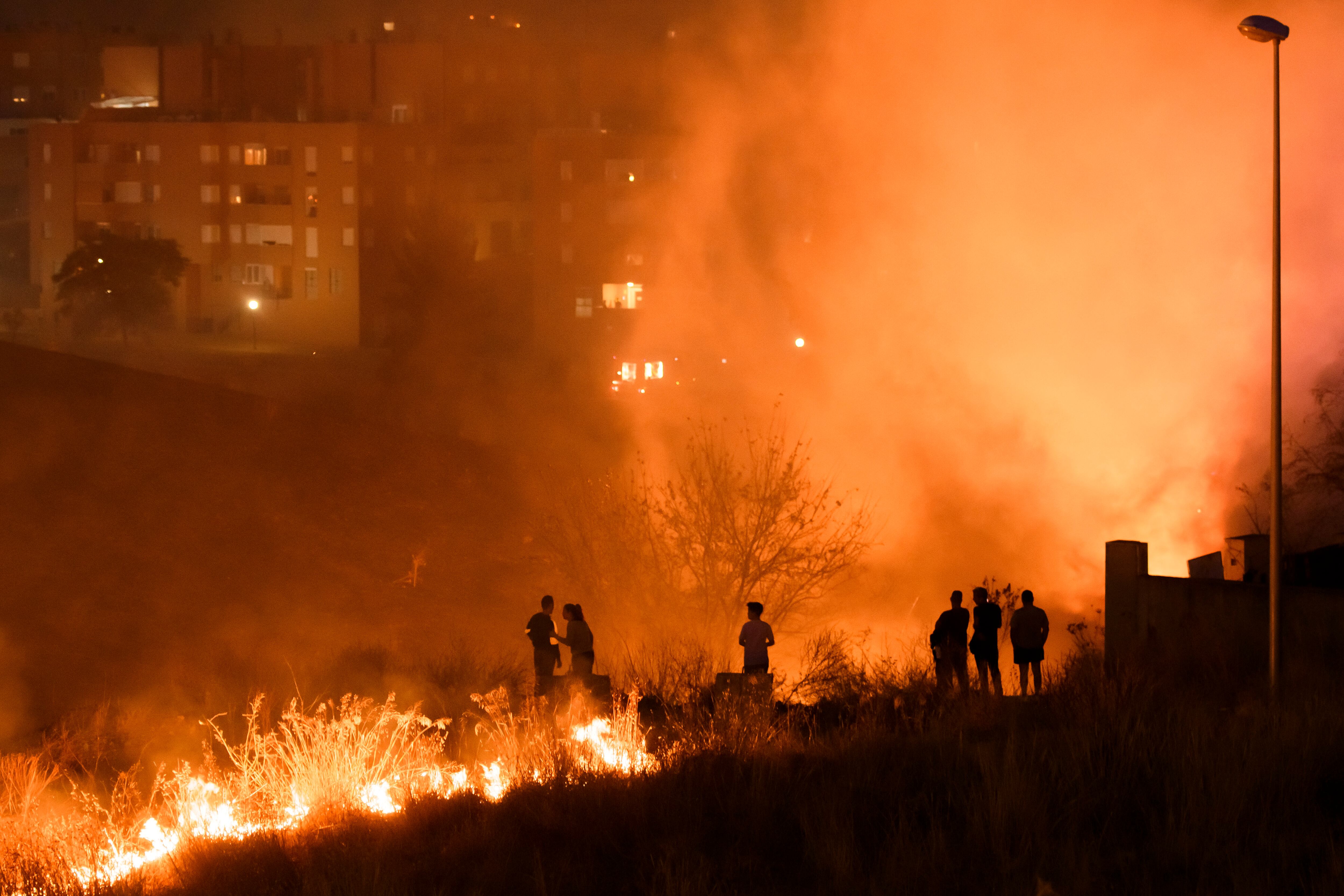 Incendio presuntamente provocado en una zona de pastos de la localidad de Camas (Sevilla) que ha obligado al desalojo preventivo de varias viviendas ocupadas y a la atención de varias personas por inhalación de humos. EFE/Raúl Caro