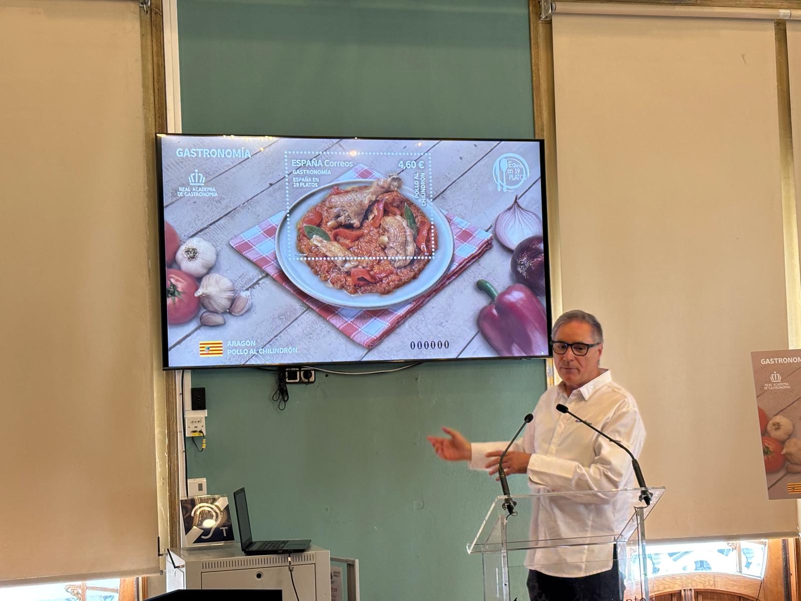 El cocinero Carmelo Bosque explicando el plato de pollo al chilindrón que cocinó y que ilustra el sello