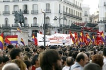 Varias personas portan banderas republicanas durante una concentración en la Puerta del Sol de Madrid a favor de la República