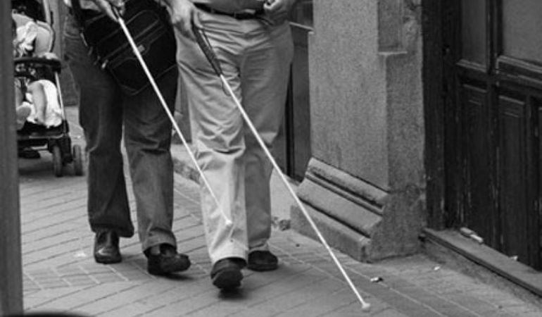 Dos personas caminando por la calle con bastones para invidentes en una imagen de archivo.