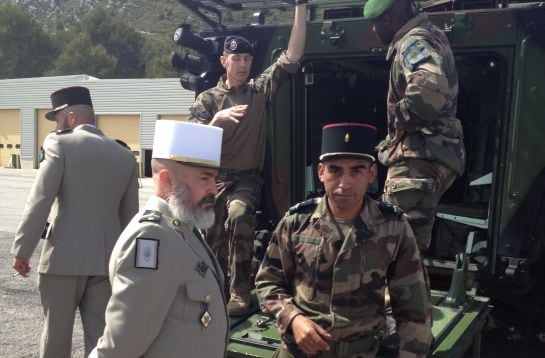 El cabo Alonso y el suboficial José muestran un vehículo blindado a los periodistas