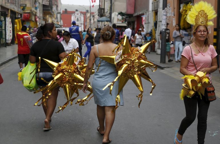 Los peruanos portan piñatas y accesorios de color amarillo para celebrar el Año Nuevo. 