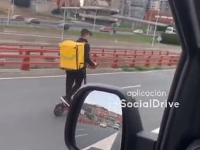 Captura del vídeo del repartidor conduciendo un patinete eléctrico por la A8