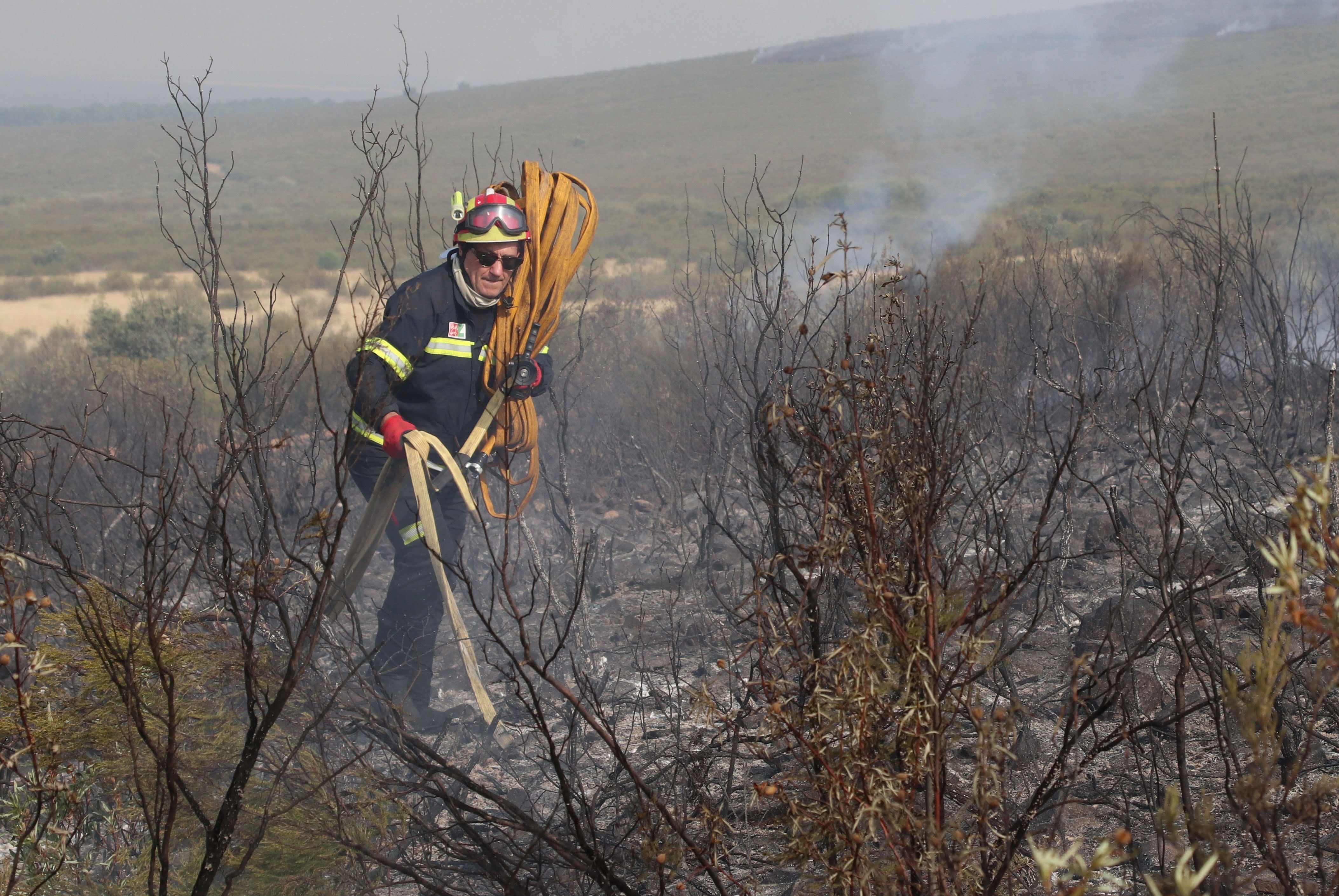 PUERCAS (ZAMORA) 12/08/2025.- El presidente de la Diputación de Zamora, Javier Faúndez, que durante ocho años estuvo al frente el parque de bomberos de Aliste, se ha puesto el traje de profesional de extinción, ha cogido la manguera y ha estado en primera línea de fuego en los incendios de Molezuelas de la Carballeda y Puercas. EFE/Mariam A. Montesinos