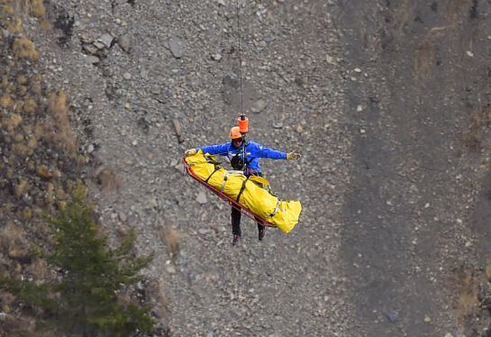 ALTERNATIVE CROP  A helicopter lifts an investigator near scattered debris on the crash site of the Germanwings Airbus A320 that crashed in the French Alps above the southeastern town of Seyne. The young co-pilot of the doomed Germanwings flight that cras