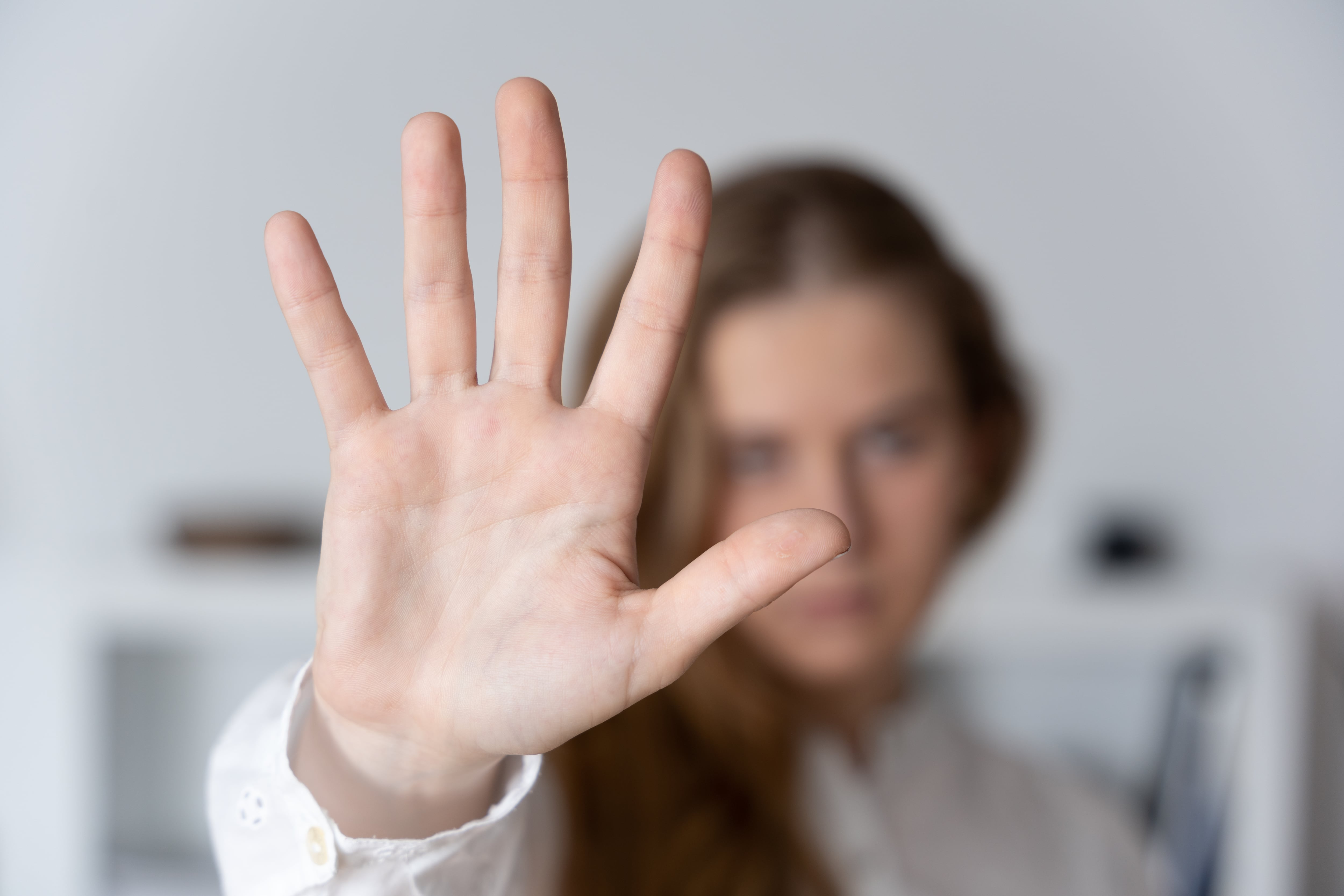 Woman making stop sign with hand. Domestic and sexual violence concept