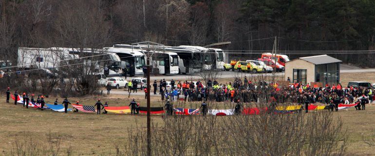 LE VERNET, FRANCE - MARCH 26: Rescue workers hold up flags representing the nationalities of those killed onboard Germanwings flight 4U9525 as friends and relatives arrive at a reception centre on March 26, 2015 in Le Vernet, France. Germanwings flight 4U9525 from Barcelona to Dusseldorf crashed in Southern French Alps on Tuesday. All onboard perished. French authorities say that it appeared that the co-pilot wanted to "destroy the plane". (Photo by Patrick Aventurier/Getty Images)