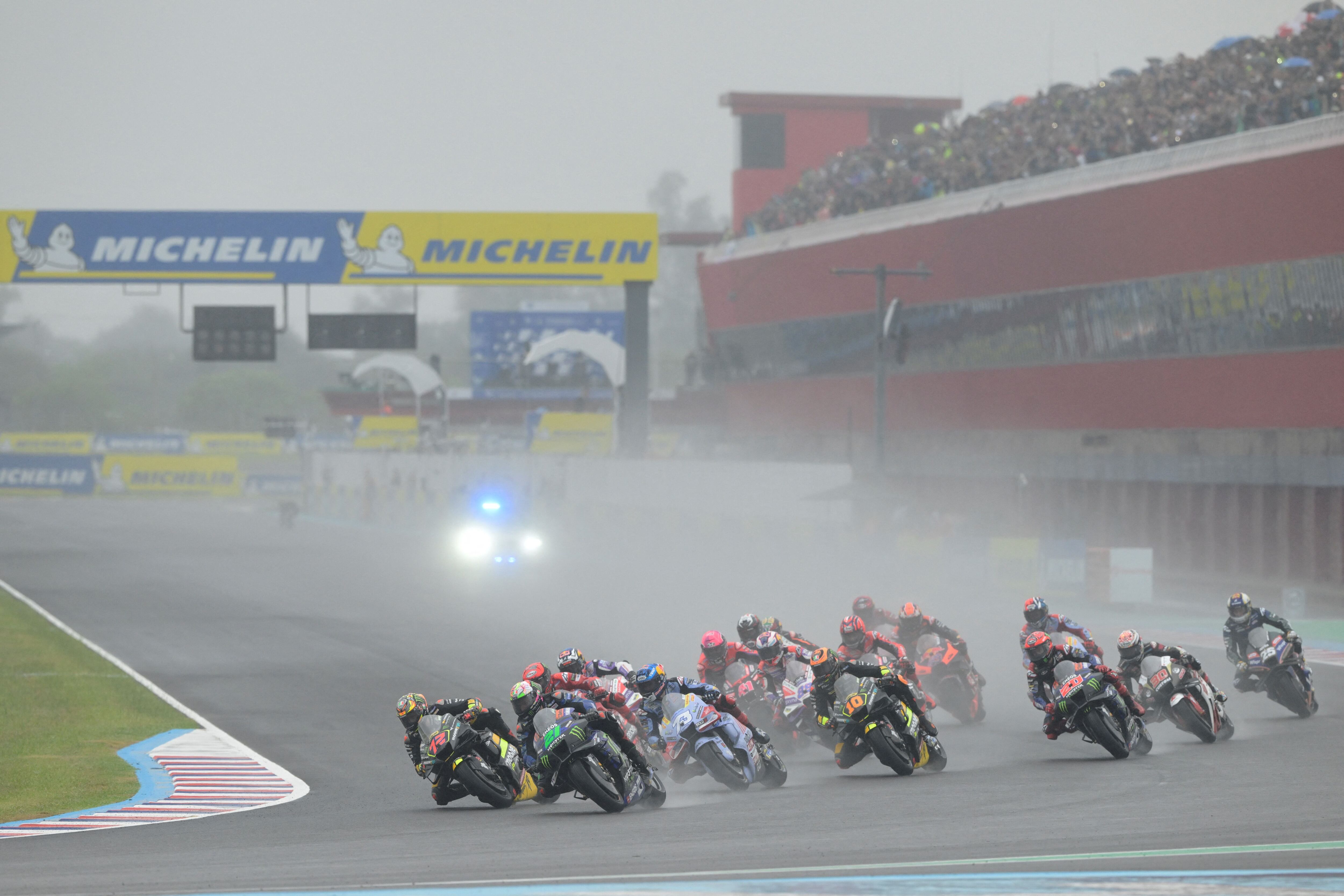 Riders take the first turn at the start of the Argentina Grand Prix MotoGP race, at Termas de Rio Hondo circuit, in Santiago del Estero, Argentina, on April 2, 2023. (Photo by JUAN MABROMATA / AFP) (Photo by JUAN MABROMATA/AFP via Getty Images)