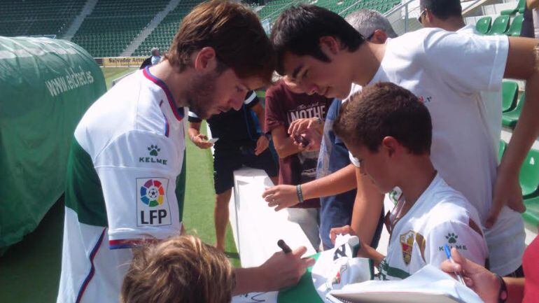 Ilie firma una camiseta a un joven aficionado