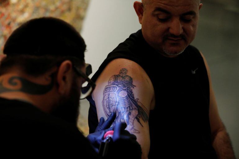 Gabi Shoval, who lost his leg during military combat while serving as a soldier in the Israeli army, gets a tattoo done by Israeli artist Alexey Zamotevsky as part of the &quot;Healing Ink &quot; project, at the Israel Museum in Jerusalem October 9, 2017. Picture t