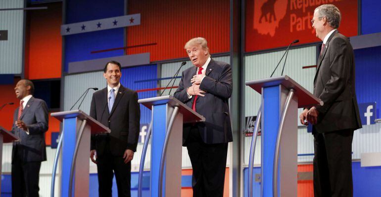 Fellow Republican 2016 U.S. presidential candidates Dr. Ben Carson (L), Wisconsin Governor Scott Walker (2nd L) and former Florida Governor Jeb Bush (R) laugh as fellow candidate and businessman Donald Trump (2nd R) reacts near the end of the debate after