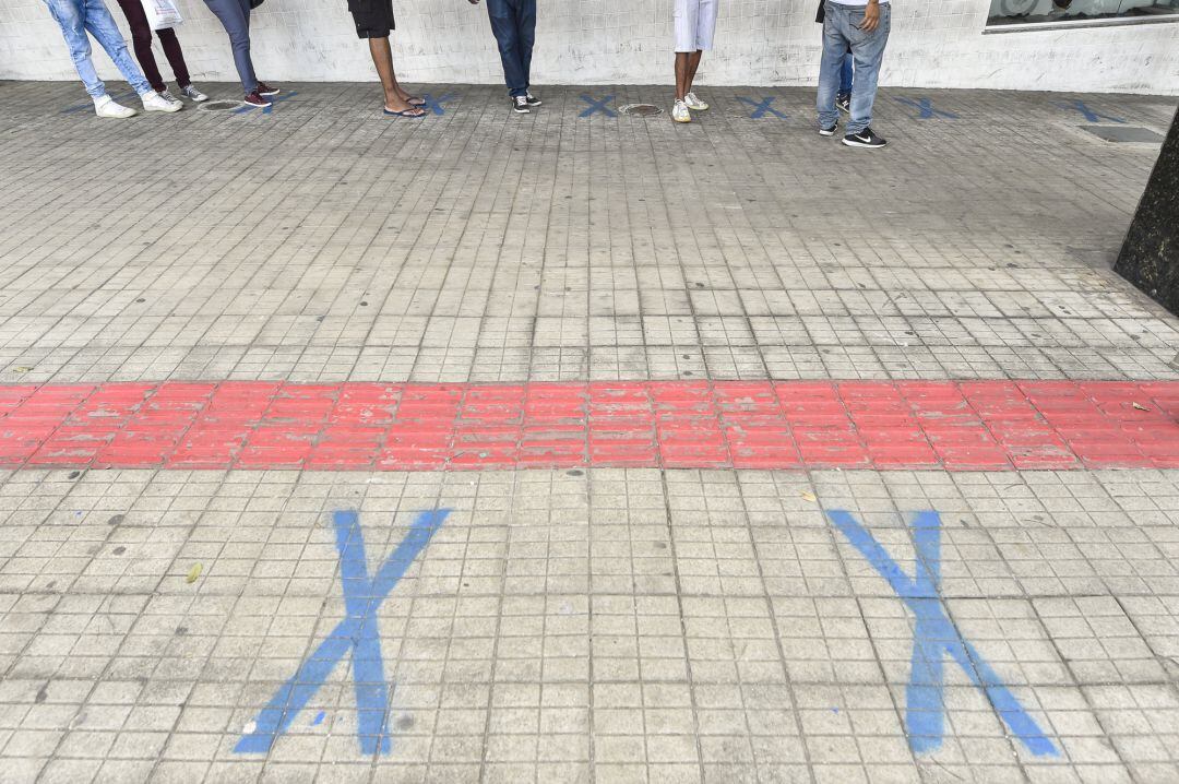 Colas ante entidades bancarias señalando los espacios vitales en las aceras