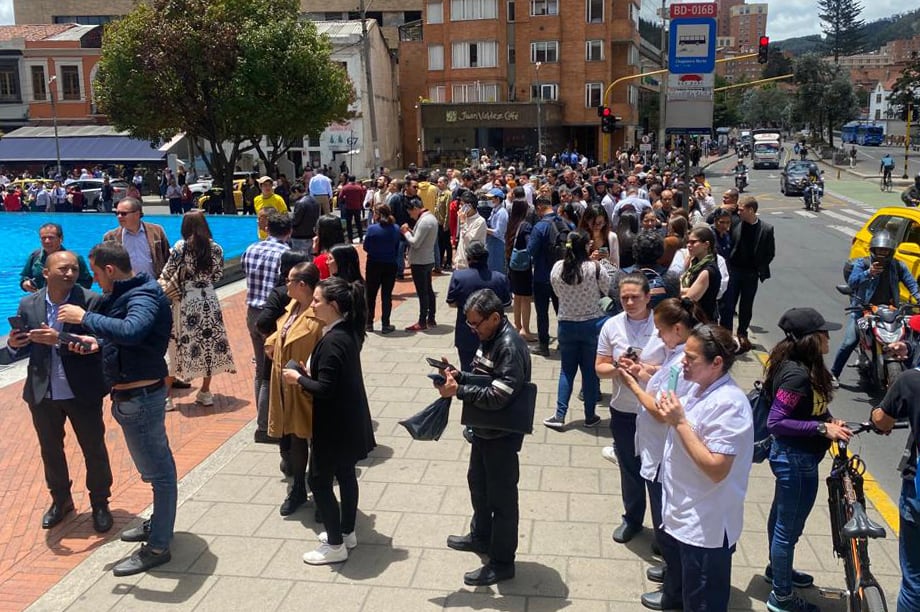 Personas se reúnen fuera de un edificio tras ser evacuadas por un temblor de 6.1 en Bogotá (Colombia)