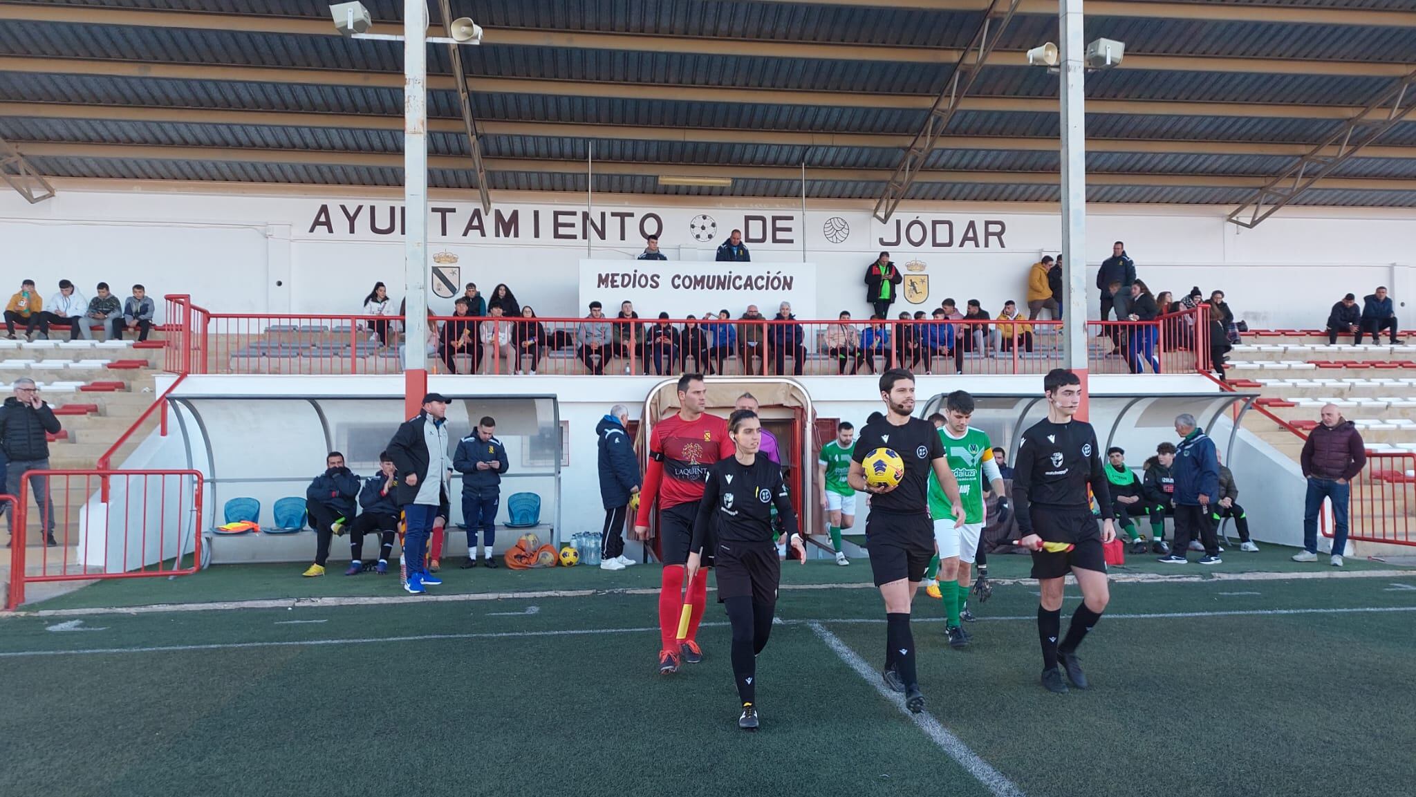 Salida del trío arbitral y equipos desde el túnel de vestuarios al terreno de juego