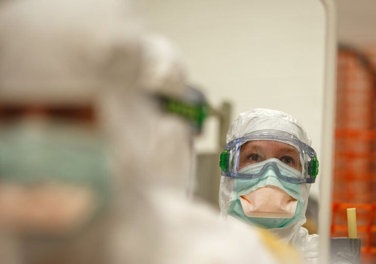 AMSTERDAM, NETHERLANDS - NOVEMBER 12:  A trainee wearing protective glasses is reflected in a mirror during the Ebola training program on November 12, 2014 in Amsterdam, Netherlands. Doctors Without Borders has established a training program in a reproduc