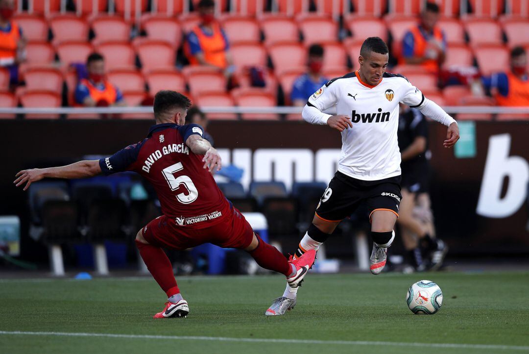 VALENCIA, SPAIN - JUNE 21: Rodrigo Moreno of Valencia CF  battles for possession with Raul Navas of CA Osasuna during the La Liga match between Valencia CF and CA Osasuna at Estadio Mestalla on June 21, 2020 in Valencia, Spain. 