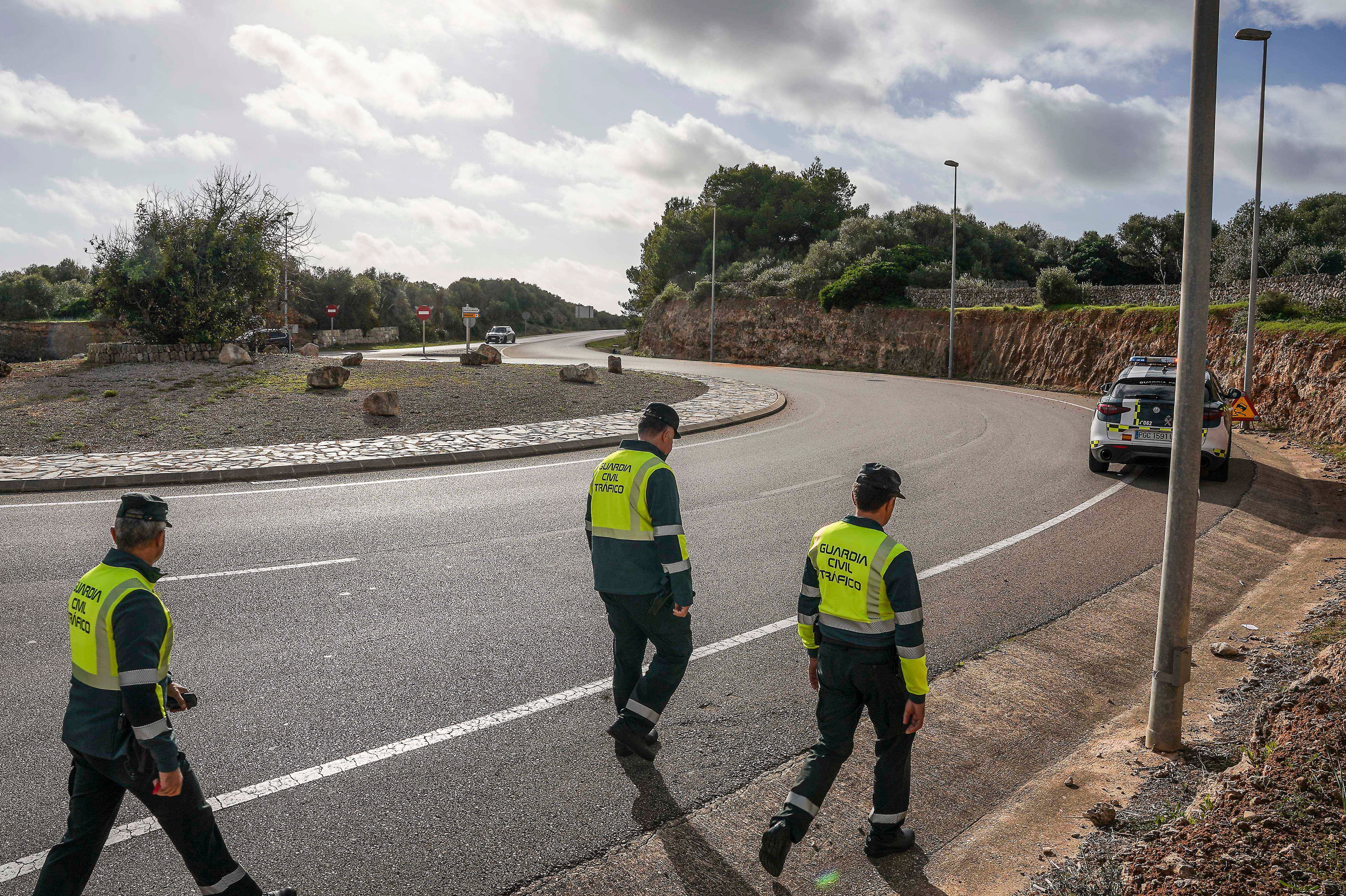 MAHÓN (MENORCA), 24/11/2024.- La Guardia Civil apunta al exceso de velocidad como una de las causas del accidente mortal que anoche costó la vida a los seis ocupantes, cuatro de ellos menores, de un coche que se salió de la vía en una rotonda en el kilómetro 0&#039;5 de la carretera de acceso al aeropuerto de Menorca (Me-14). El vehículo, que acababa de superar otra rotonda a aproximadamente medio kilómetro de distancia, acabó colisionando con un muro rocoso de más de tres metros de altura y todos los ocupantes fallecieron en el acto. En la imagen, agentes de la Guardia Civil en el lugar del accidente, este domingo. EFE/David Arquimbau Sintes
