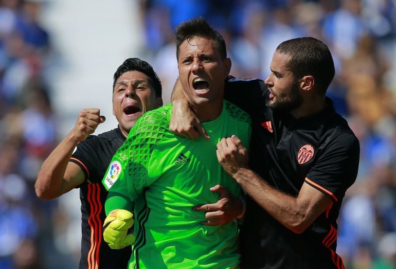 LEGATES, SPAIN - SEPTEMBER 25: Goalkeeper Diego Alves (2ndL) of Valencia CF celebrates stopping a penalty shot with teammates Mario Suarez (R) and Enzo Perez (L) during the La Liga match between CD Leganes and Valencia CF at Estadio Municipal de Butarque 