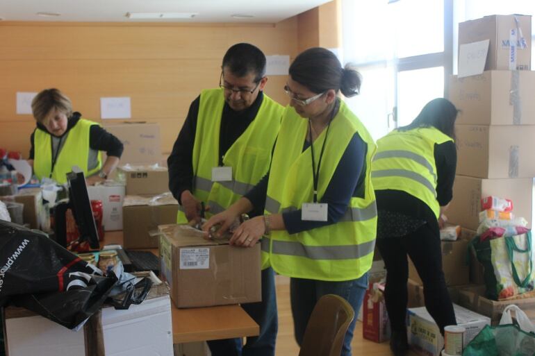 Algunos voluntarios preparan cajas de recursos que serán enviadas hasta Ecuador en cuanto el centro de coordinación de Coslada esté preparado