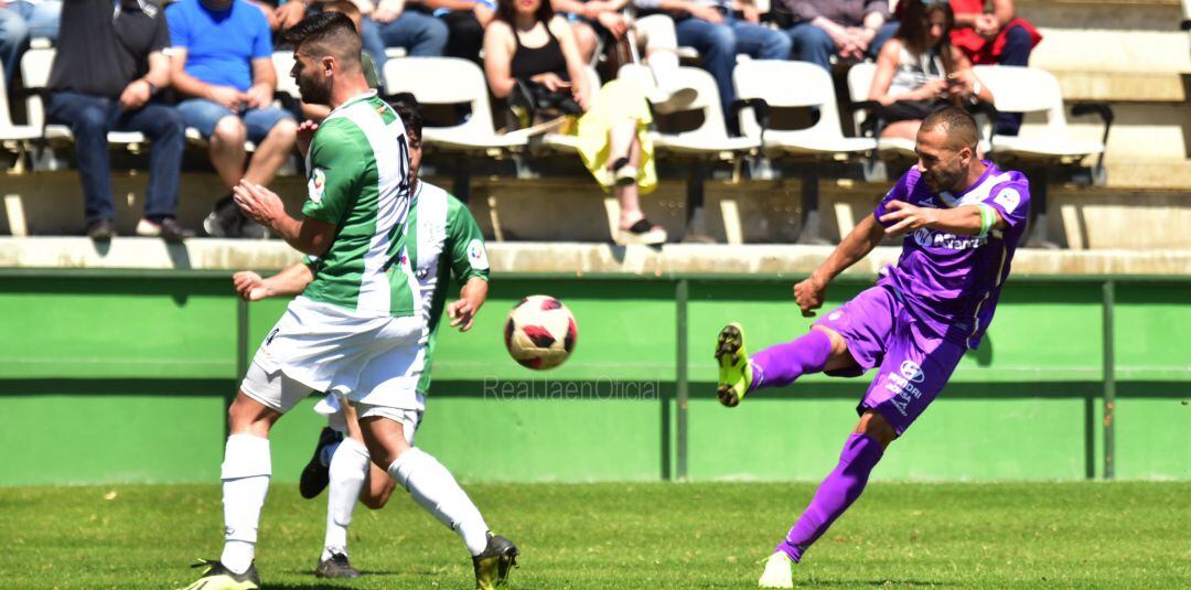 Choco golpea el balón en presencia de dos jugadores del Torremolinos.