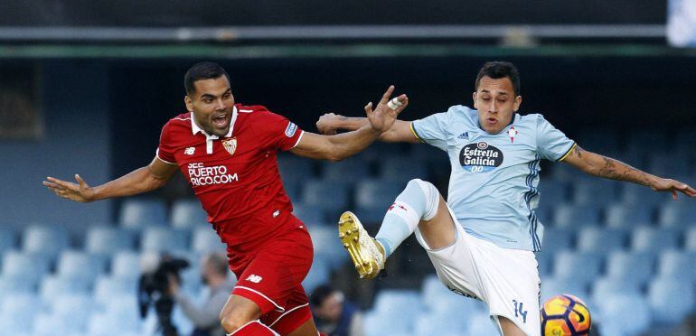 El centrocampista chileno del Celta de Vigo, Fabián Orellana (d), pugna por un balón, con el defensa argentino del Sevilla, Gabriel Mercado (i), en el partido de la decimoquinta jornada de Liga celebrado en el estadio Balaídos de Vigo