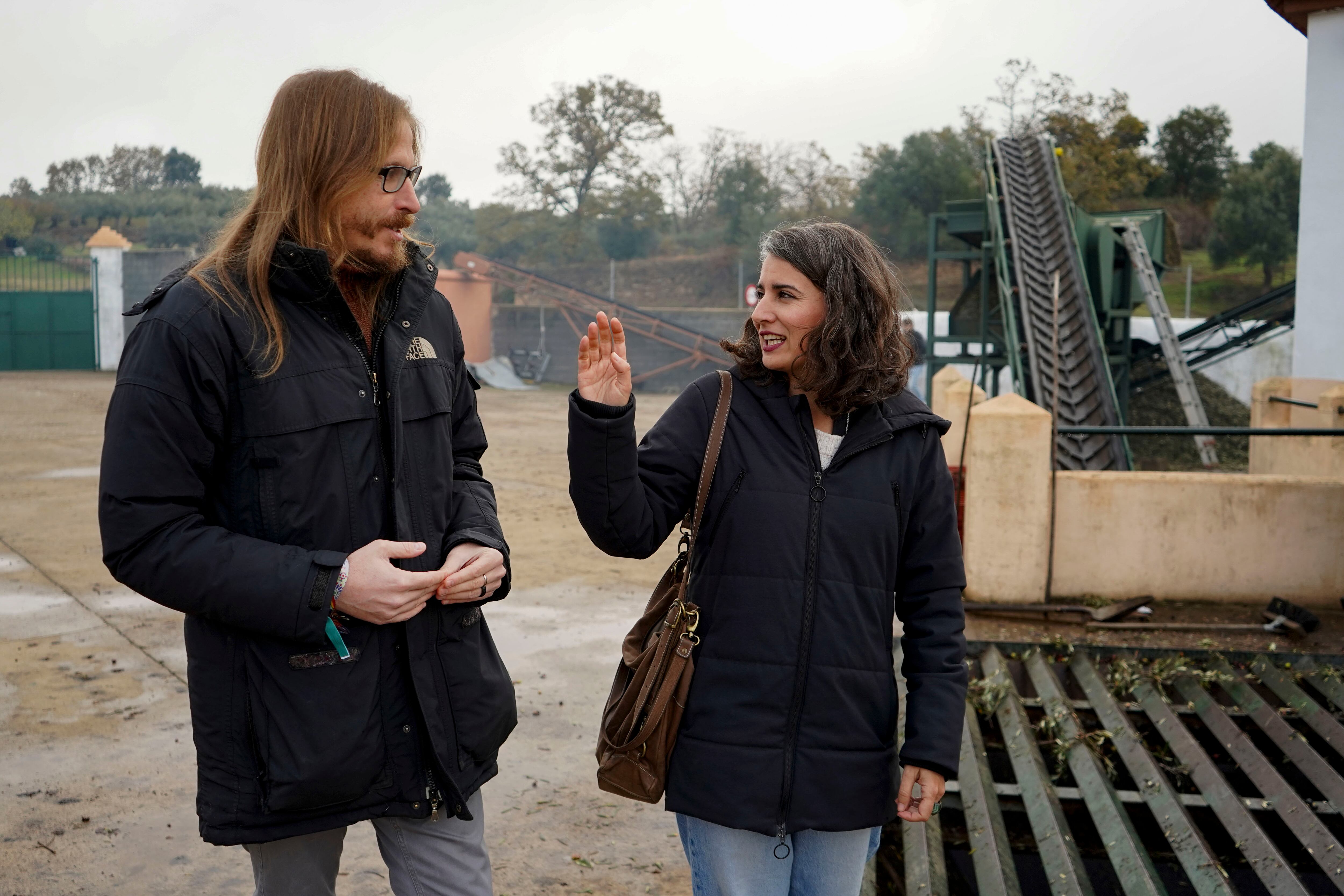 PERALES DEL PUERTO (CÁCERES), 02/12/2025.- La candidata a la Presidencia de la Junta por Unidas por Extremadura, Irene de Miguel, acompañada del secretario de Organización de Podemos, Pablo Fernández, durante una visita a la cooperativa Peraliega Almazara de San Andrés, en la localidad cacereña de Perales del Puerto, donde ha anunciado este martes un plan de revitalización de los cultivos de montaña, especialmente del olivar tradicional. EFE/EDUARDO PALOMO