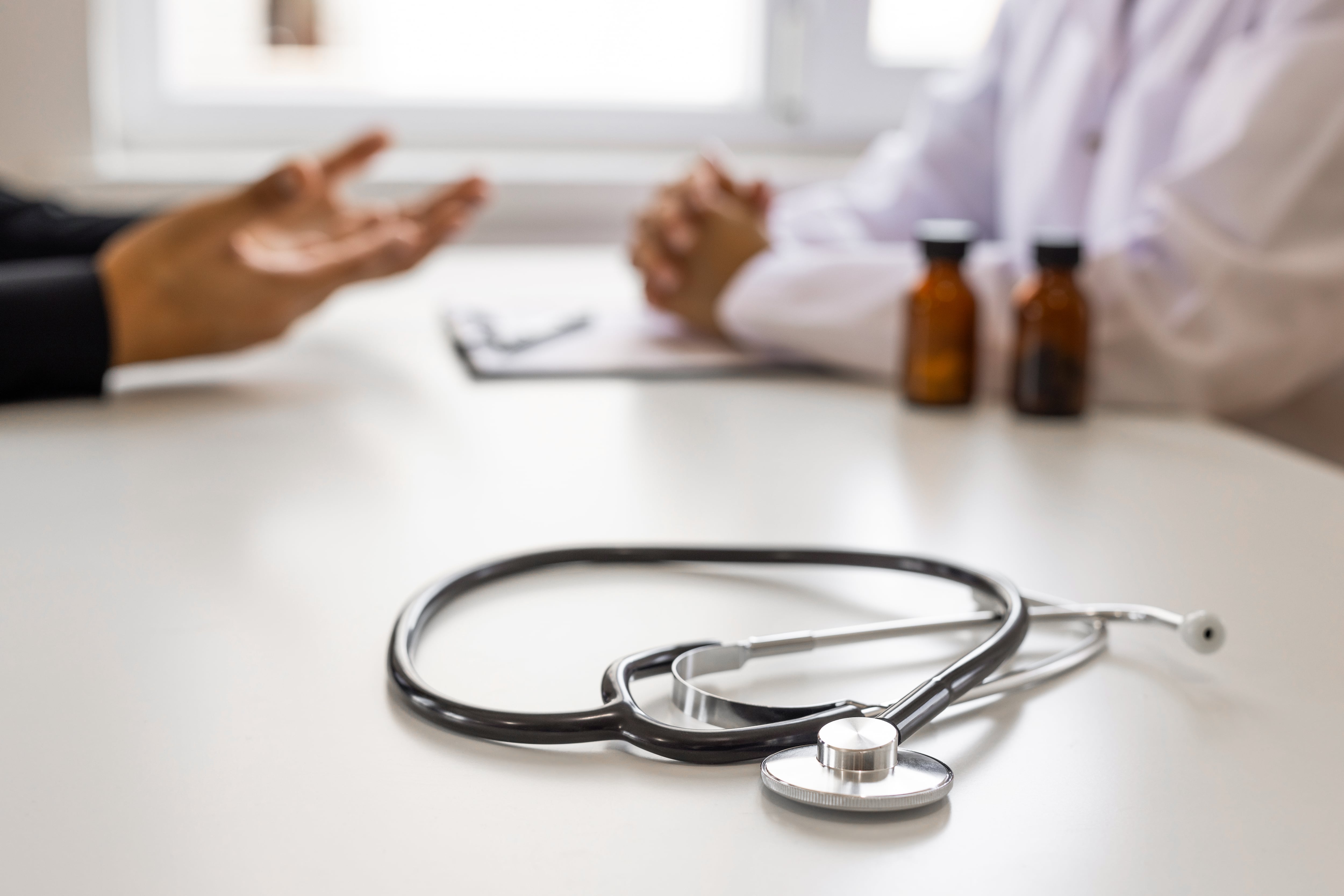 Doctor listening to patient talking at hospital